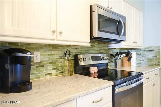 a kitchen with granite countertop a sink and a stove top oven