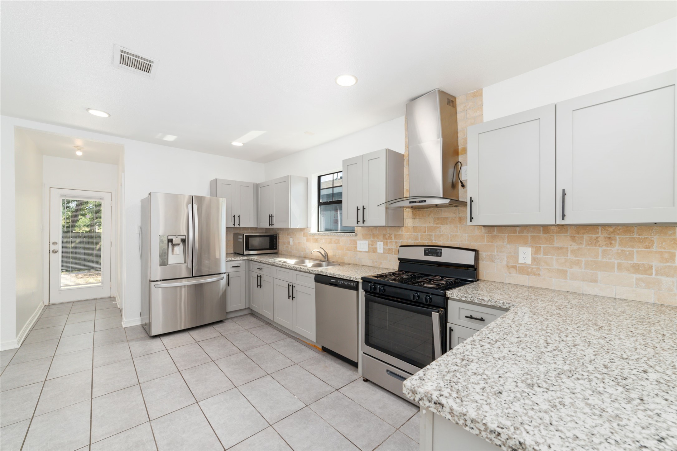 433 Calloway Street Houston, TX 77029 - Photo 11 of 29 a kitchen with stainless steel appliances granite countertop a refrigerator sink and stove