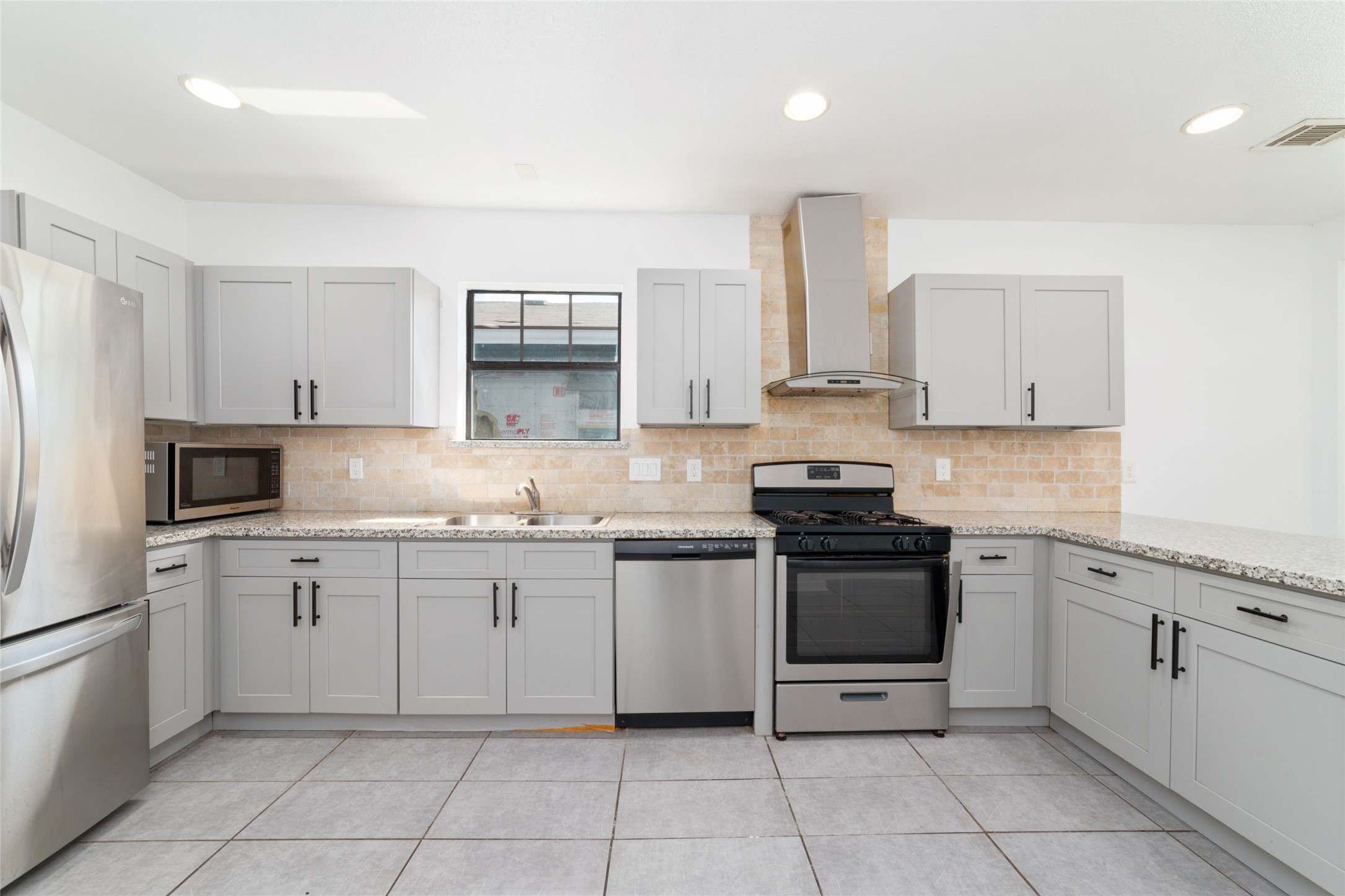 433 Calloway Street Houston, TX 77029 - Photo 13 of 29 a kitchen with granite countertop white cabinets and appliances