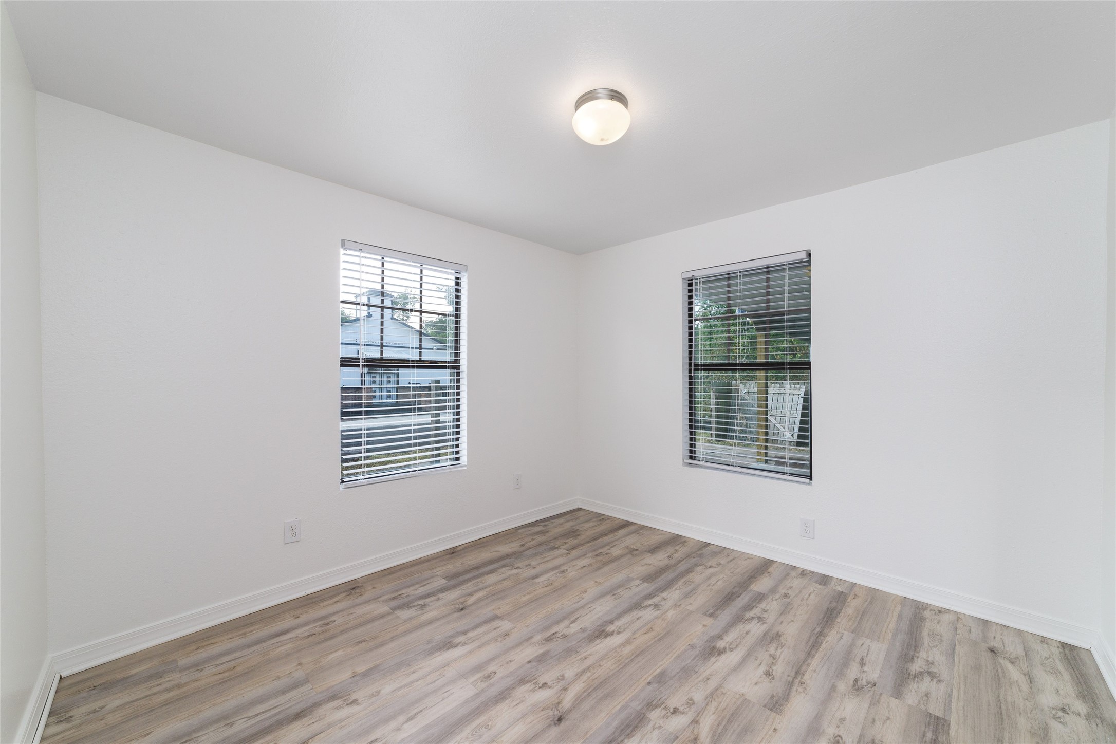 433 Calloway Street Houston, TX 77029 - Photo 17 of 29 an empty room with wooden floor and windows
