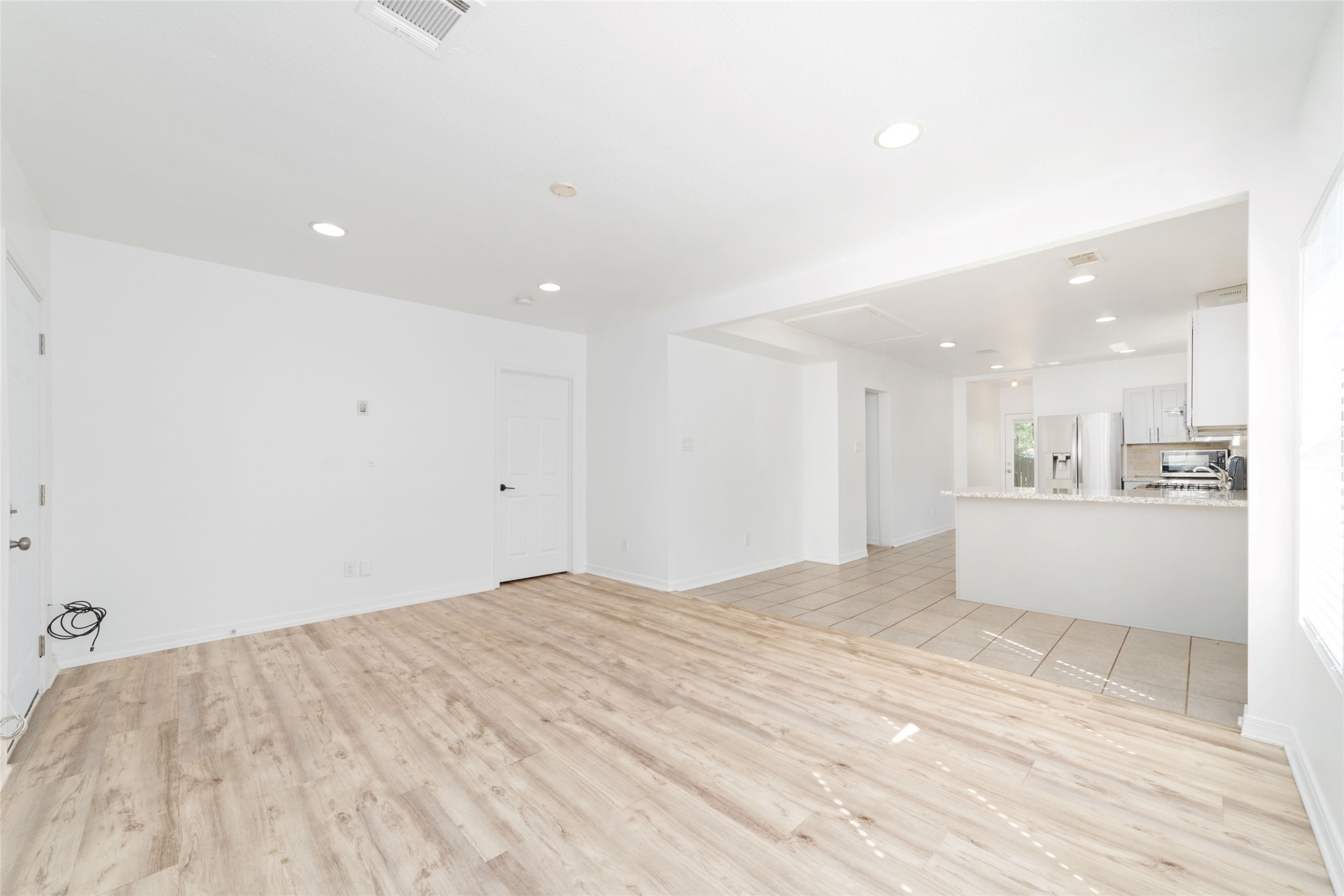 433 Calloway Street Houston, TX 77029 - Photo 9 of 29 a view of a big room with wooden floor and windows