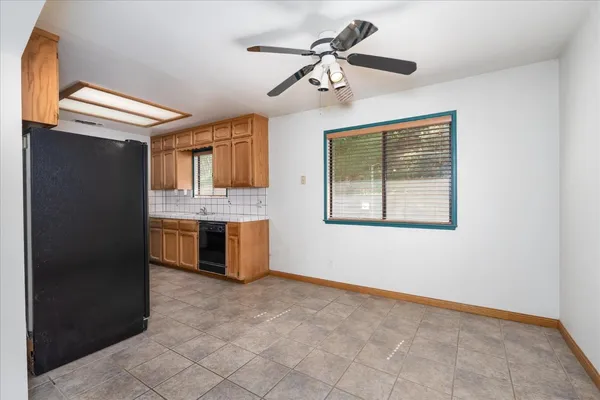 a large kitchen with stainless steel appliances granite countertop a sink and a refrigerator