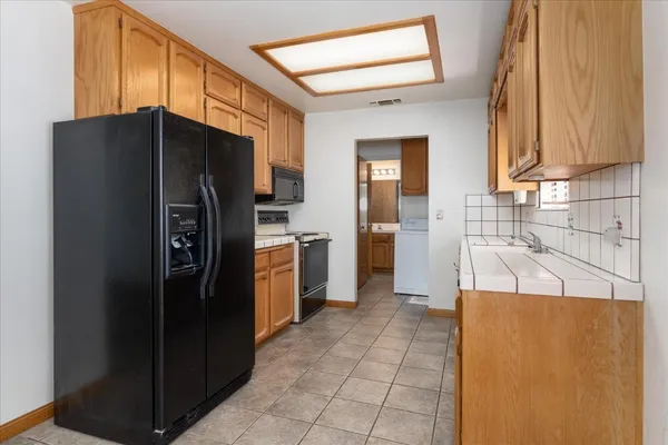 a kitchen with stainless steel appliances a refrigerator and a sink