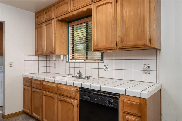 a kitchen with stainless steel appliances granite countertop a sink and a cabinets