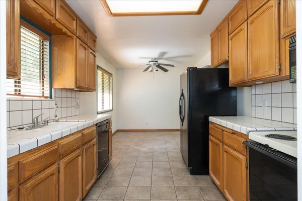 a kitchen with a sink stove and refrigerator