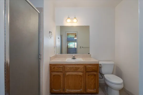a bathroom with a sink toilet and mirror
