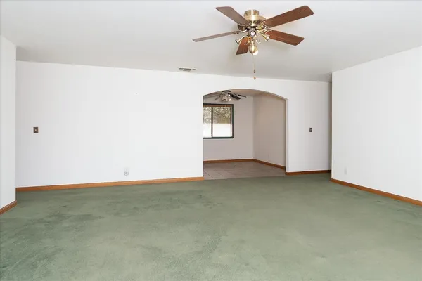 a view of a room with a ceiling fan and a chandelier fan