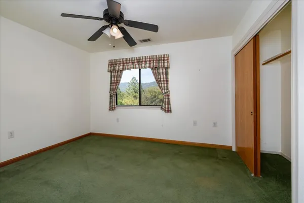 a view of room with window and ceiling fan
