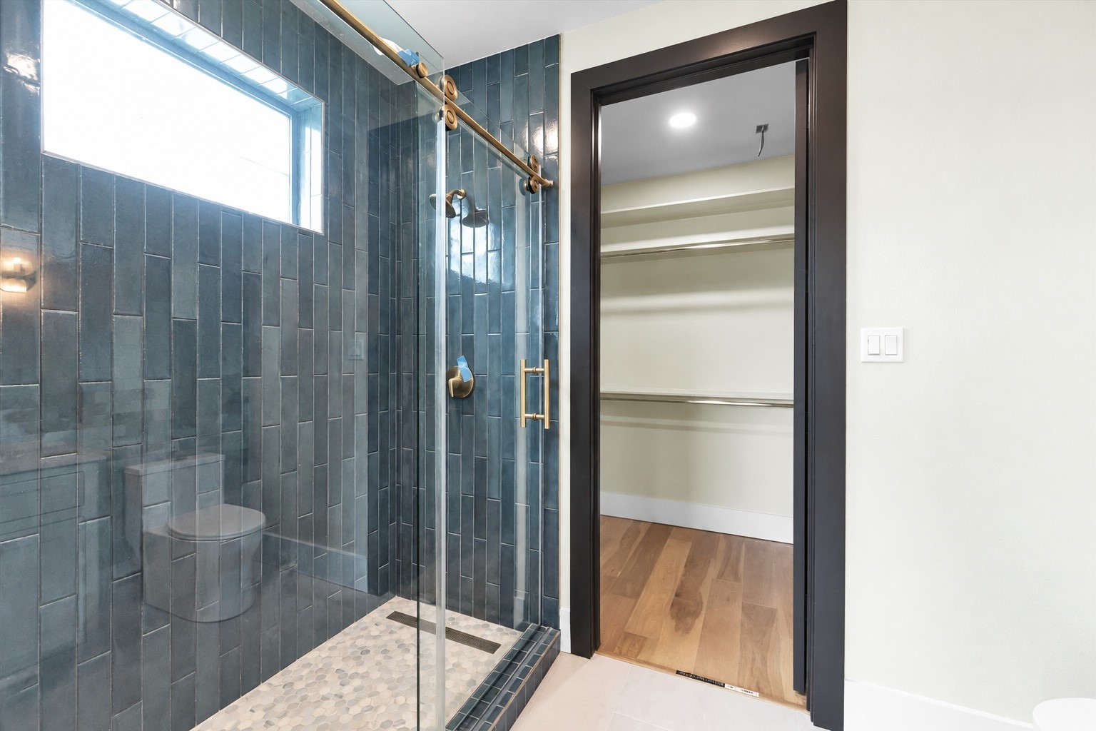 23701 Birch Grove Road Montgomery, TX 77316 - Photo 37 of 50 Experience the luxury of a shower bathed in natural light, featuring elegant floor-to-ceiling tile.