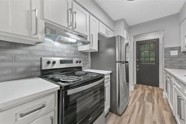 a kitchen with stainless steel appliances granite countertop a stove and a refrigerator