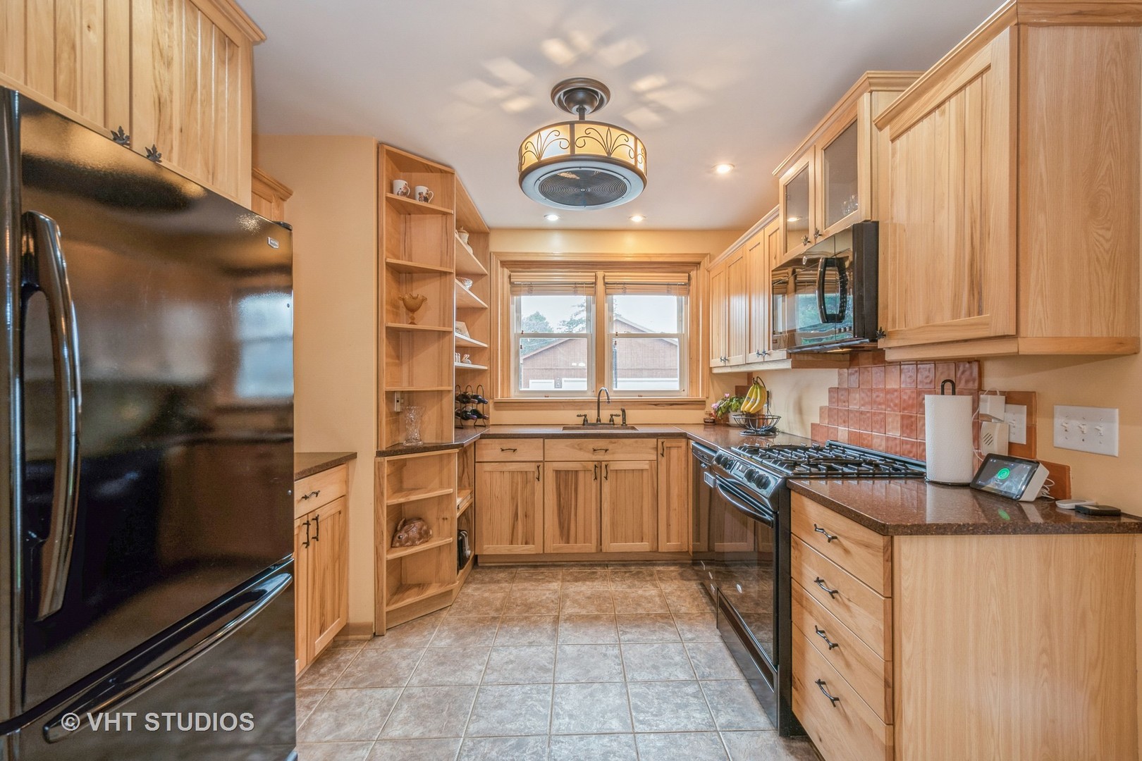 697 Greenview Avenue Des Plaines, IL 60016 - Photo 7 of 25 a kitchen with stainless steel appliances granite countertop a stove a sink and a refrigerator