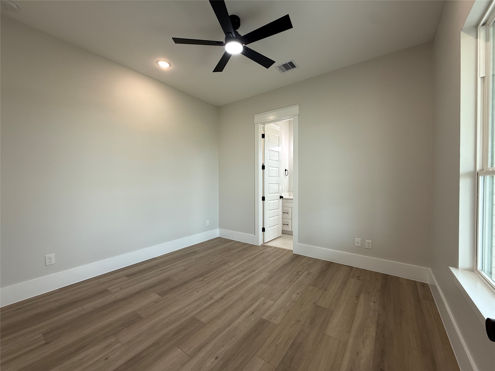 1208 Quarter Horse Trail Angleton, TX 77515 - Photo 14 of 23 an empty room with wooden floor and windows