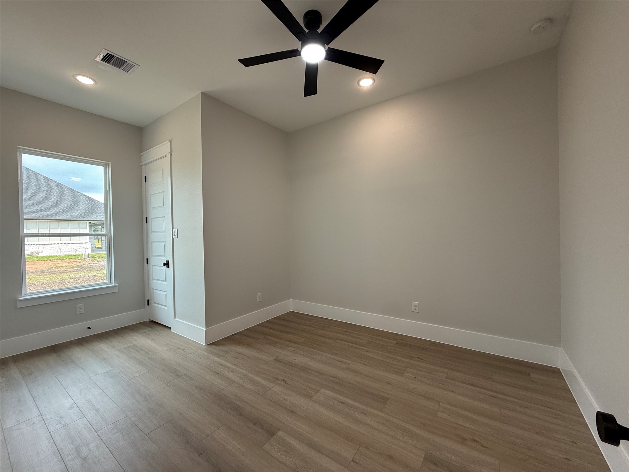 1208 Quarter Horse Trail Angleton, TX 77515 - Photo 15 of 23 wooden floor in an empty room with a window