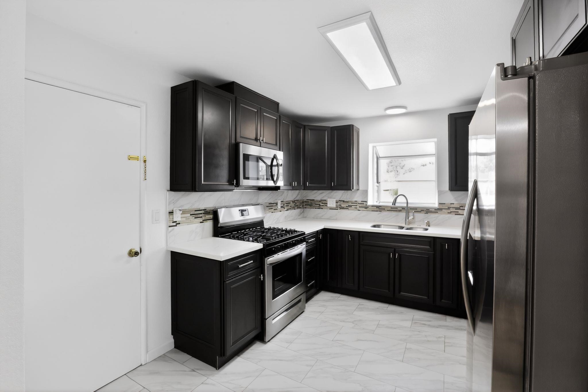 3287 Kelly Street Hayward, CA 94541 - Photo 12 of 32 a kitchen with stainless steel appliances granite countertop a refrigerator and a stove top oven