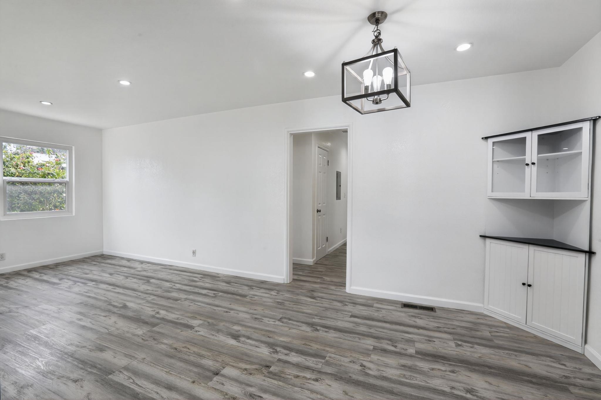 3287 Kelly Street Hayward, CA 94541 - Photo 17 of 32 an empty room with wooden floor and windows