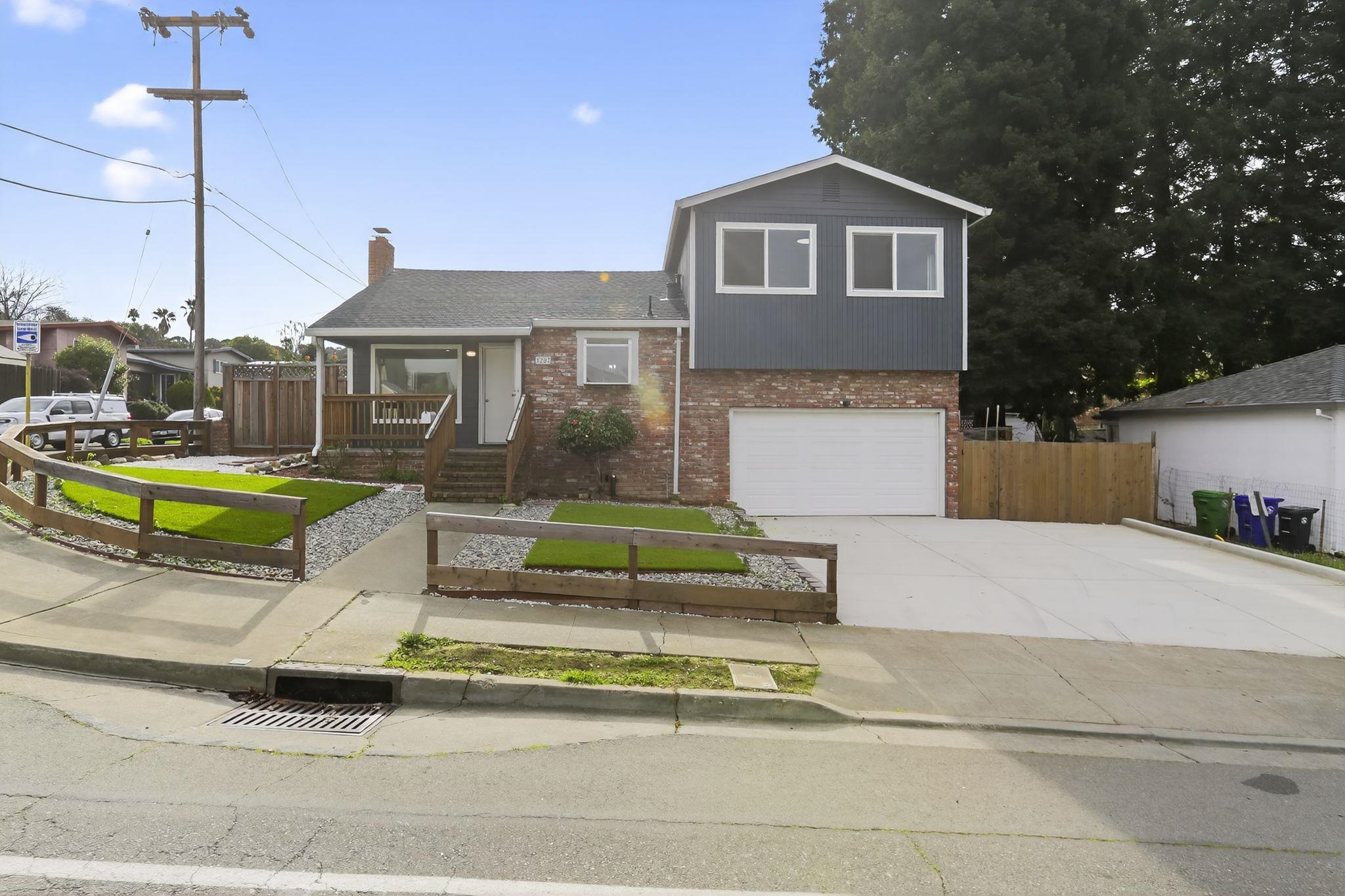 3287 Kelly Street Hayward, CA 94541 - Photo 3 of 32 a front view of a house with a garden and plants