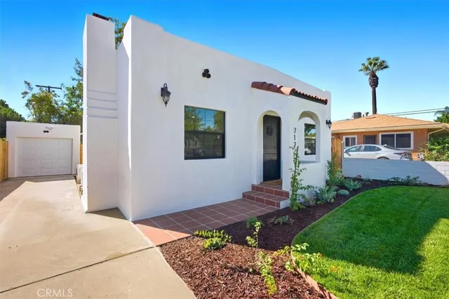 a front view of a house with garden