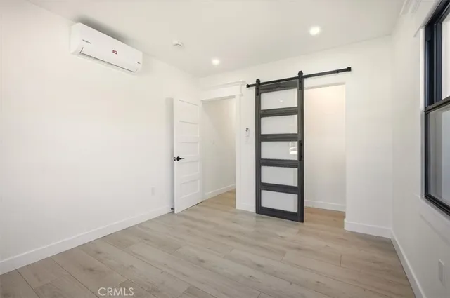 an empty room with closet and wooden floor