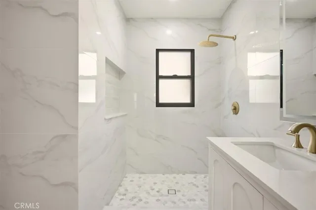 a bathroom with a sink a shower and a mirror