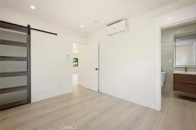 a view of empty room with wooden floor and cabinet