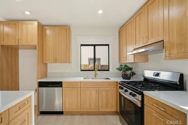 a kitchen with a stove and a white cabinets