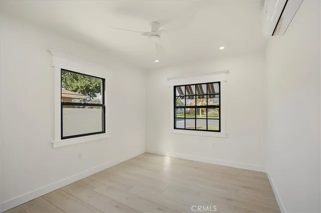 an empty room with windows and closet