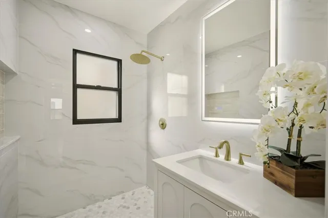 a bathroom with a sink a vanity and a mirror