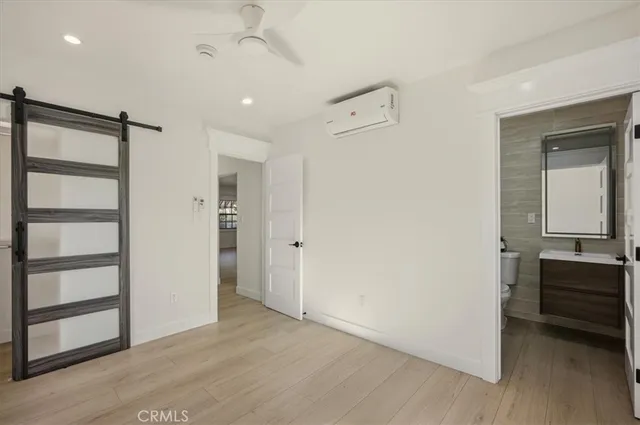 a view of a room with wooden floor and cabinet