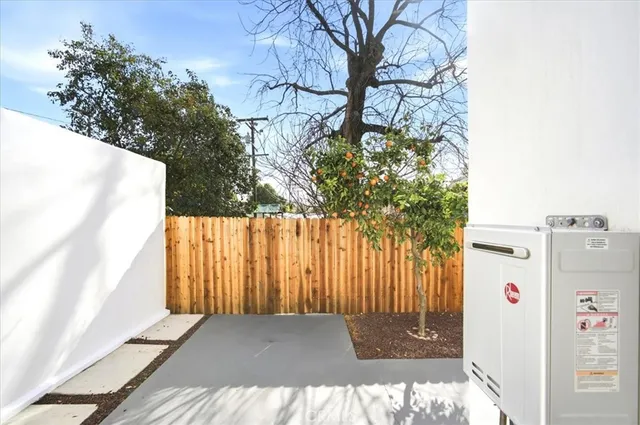 a view of backyard with white wall and sign