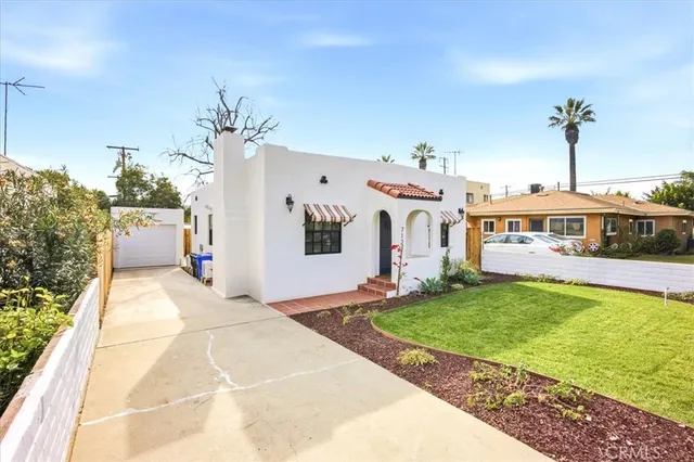 a very nice looking house with a big yard