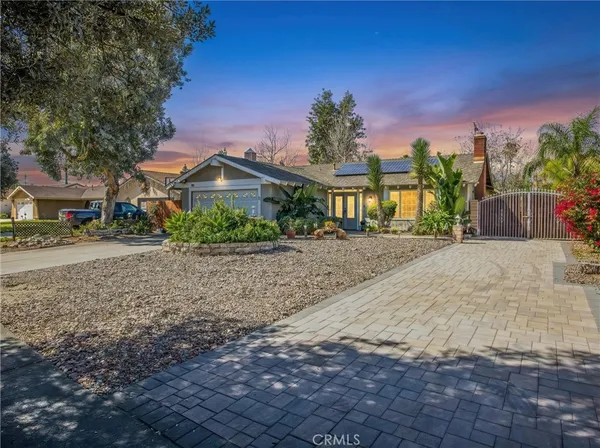 a view of a house with a yard and tree s
