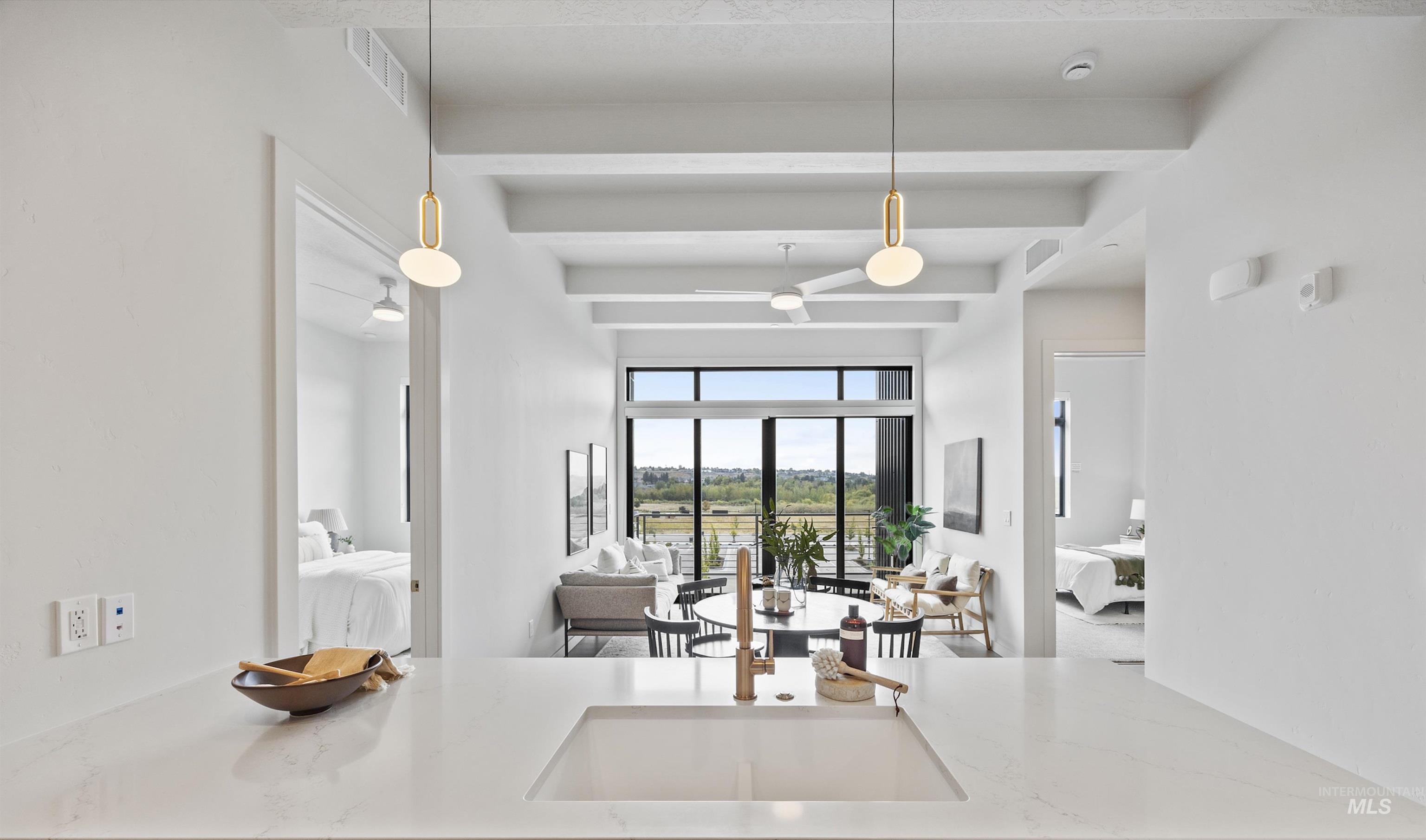 4340 East Haystack Street, Unit 305 Boise, ID 83716 - Photo 49 of 50 Kitchen with light stone countertops, pendant lighting, beamed ceiling, and open floor plan