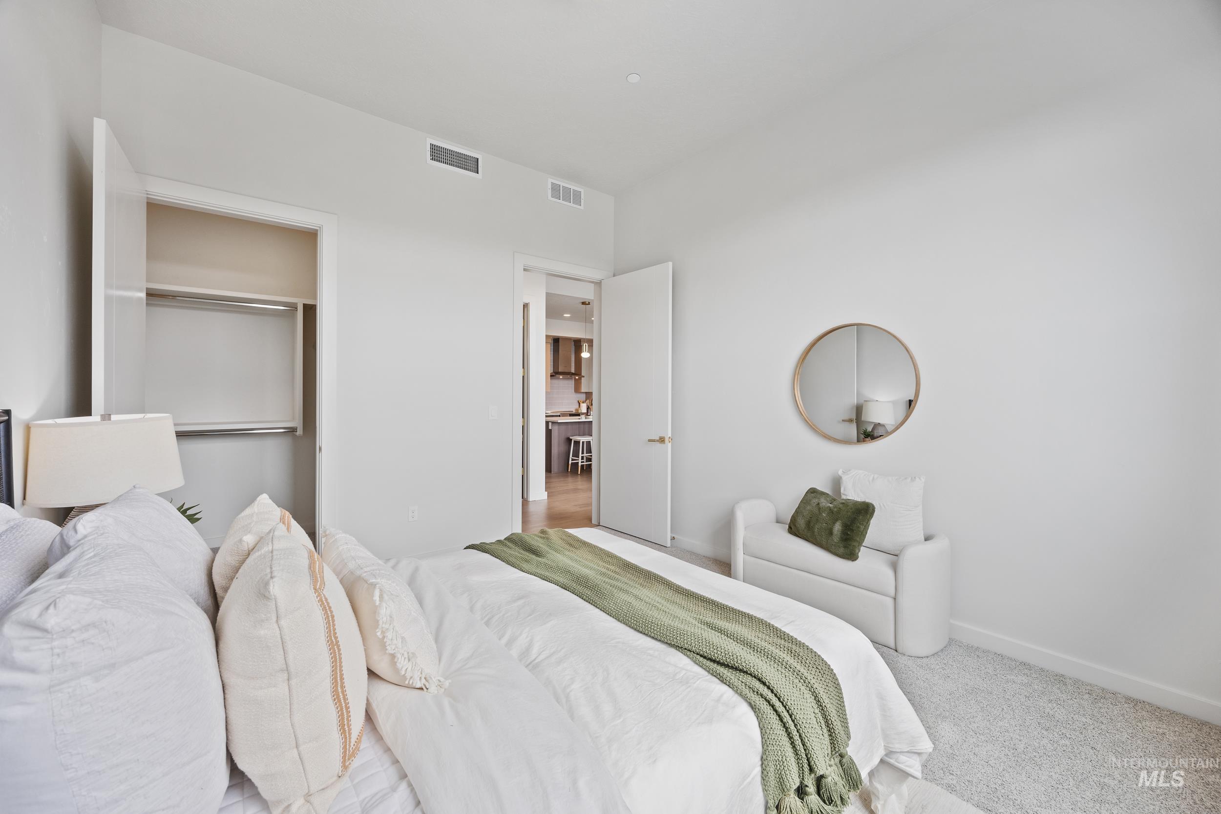 4340 East Haystack Street, Unit 305 Boise, ID 83716 - Photo 12 of 50 Carpeted bedroom featuring baseboards and a closet