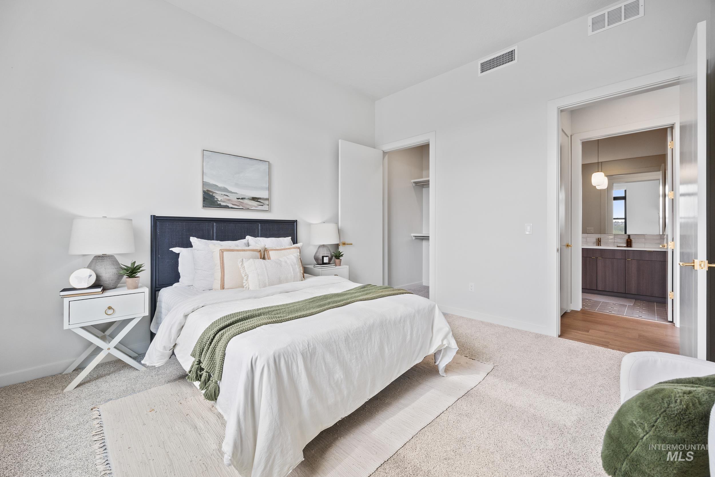 4340 East Haystack Street, Unit 305 Boise, ID 83716 - Photo 13 of 50 Carpeted bedroom featuring a spacious closet and ensuite bath