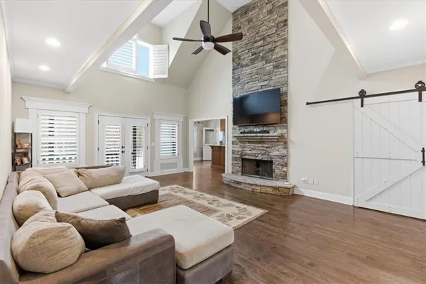 a spacious bedroom with a bed and ceiling fan