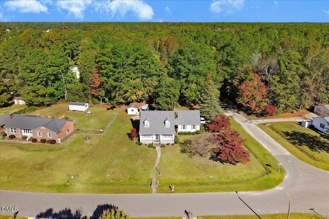 an aerial view of a residential houses with outdoor space