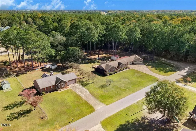 an aerial view of residential houses with outdoor space