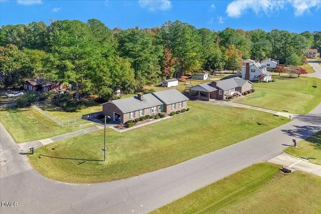 a view of a swimming pool with a yard