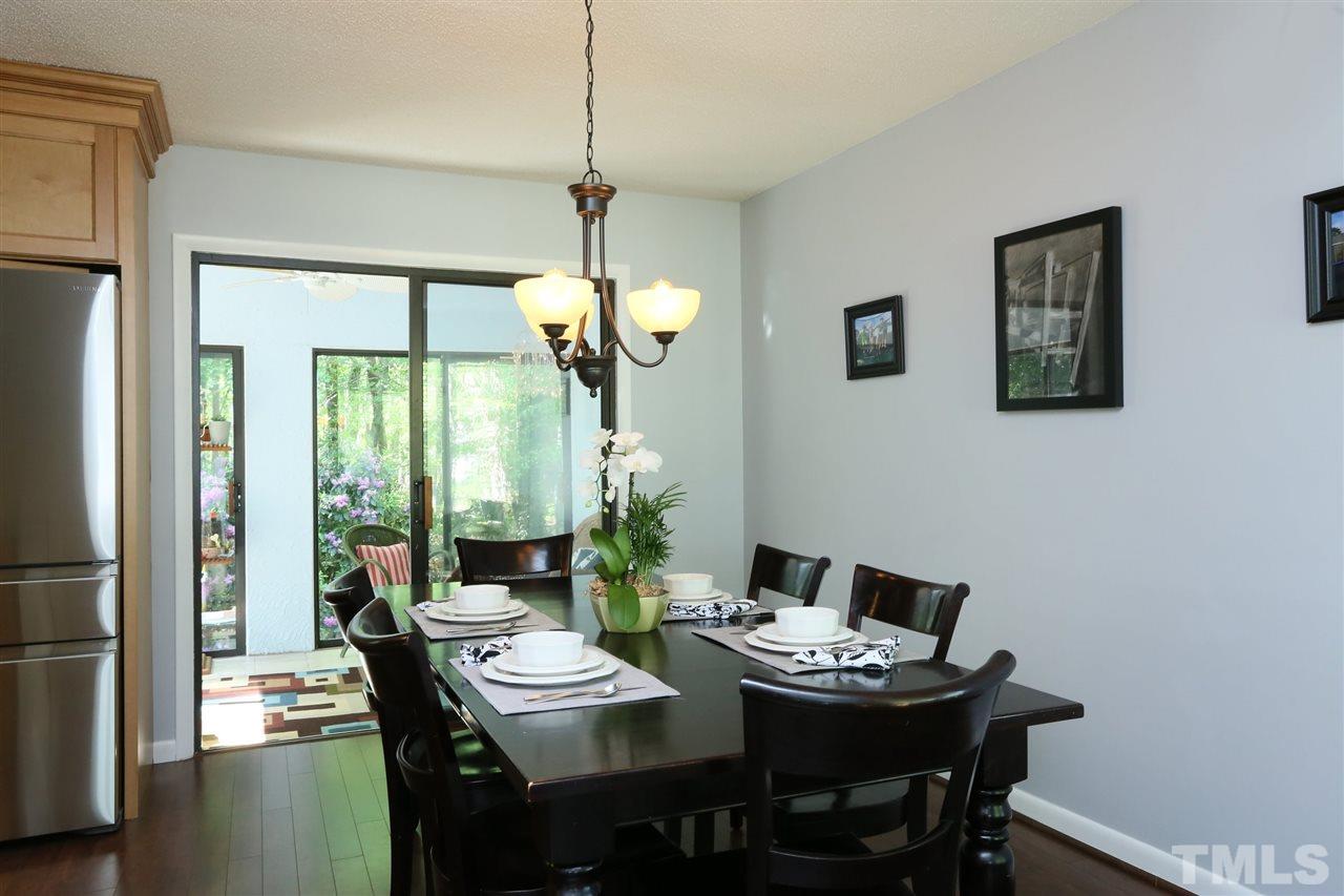 321 Bentpine Drive Raleigh, NC 27603 - Photo 12 of 30 a view of a dining room with furniture wooden floor and chandelier