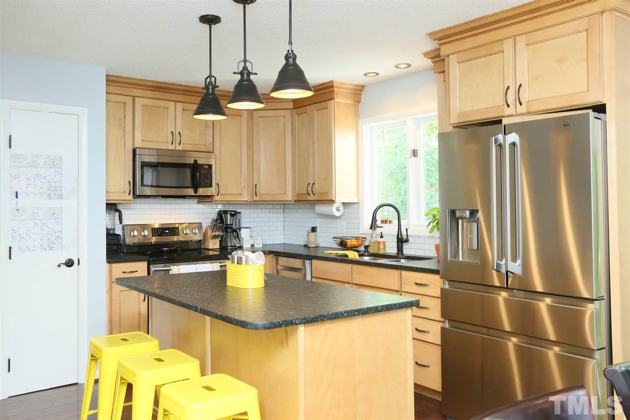 321 Bentpine Drive Raleigh, NC 27603 - Photo 13 of 30 a kitchen with stainless steel appliances granite countertop a sink a stove and a refrigerator