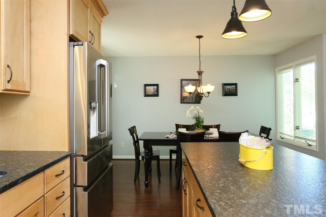 321 Bentpine Drive Raleigh, NC 27603 - Photo 15 of 30 a kitchen with a table chairs and chandelier