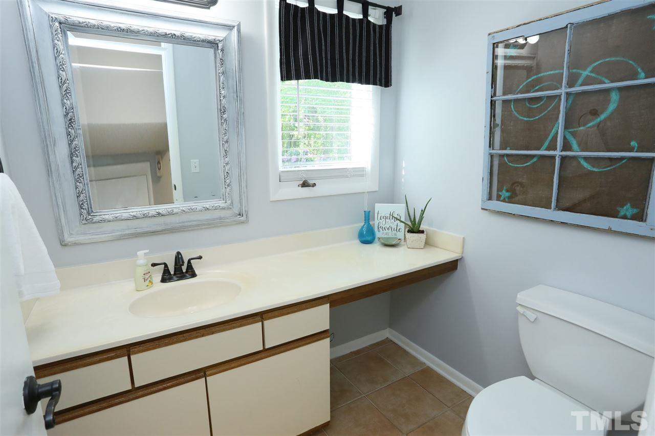 321 Bentpine Drive Raleigh, NC 27603 - Photo 23 of 30 a bathroom with a sink a toilet and a mirror