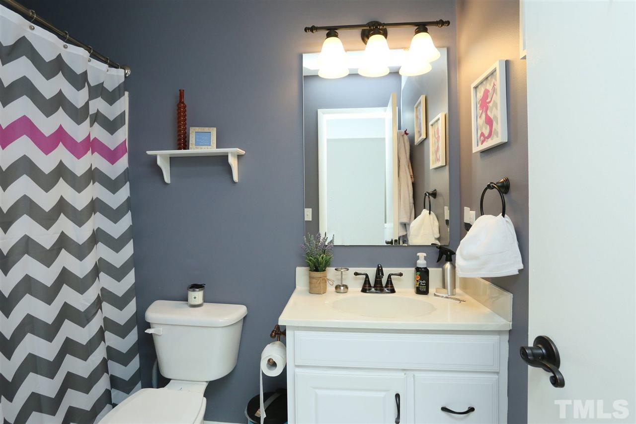 321 Bentpine Drive Raleigh, NC 27603 - Photo 28 of 30 a bathroom with a sink and mirror with toilet
