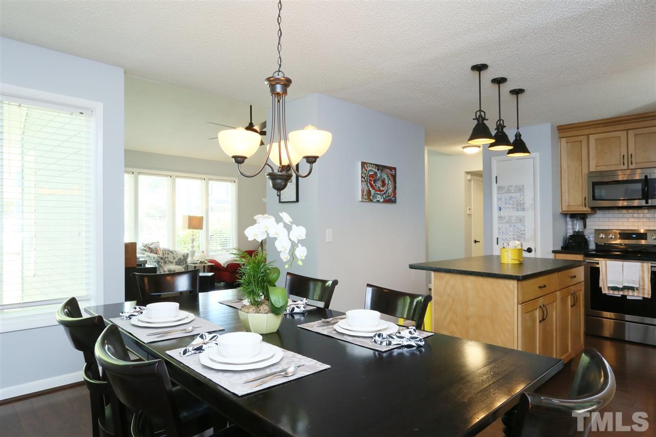 321 Bentpine Drive Raleigh, NC 27603 - Photo 10 of 30 a view of a dining room with furniture window and wooden floor