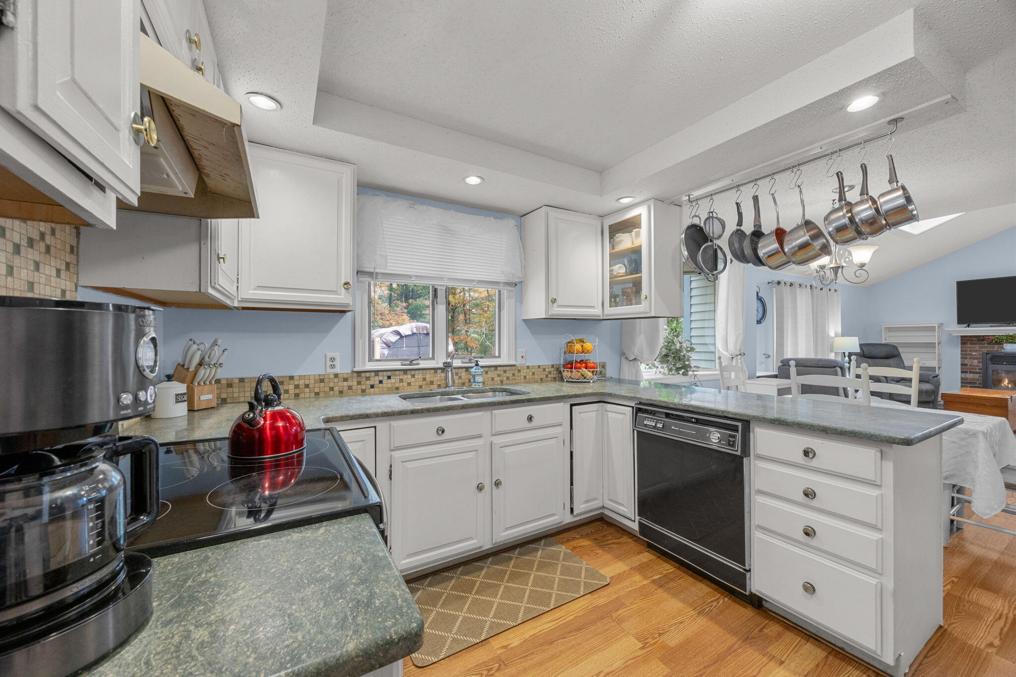 12 Beachwood Road Bourne, MA 02532 - Photo 24 of 64 a kitchen that has a lot of cabinets in it and wooden floors