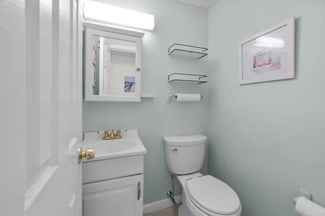 a bedroom with a bed a mirror and lamp