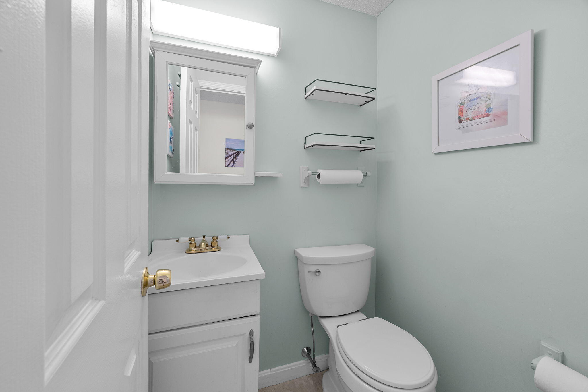 12 Beachwood Road Bourne, MA 02532 - Photo 27 of 64 a white toilet sitting next to a bathroom sink