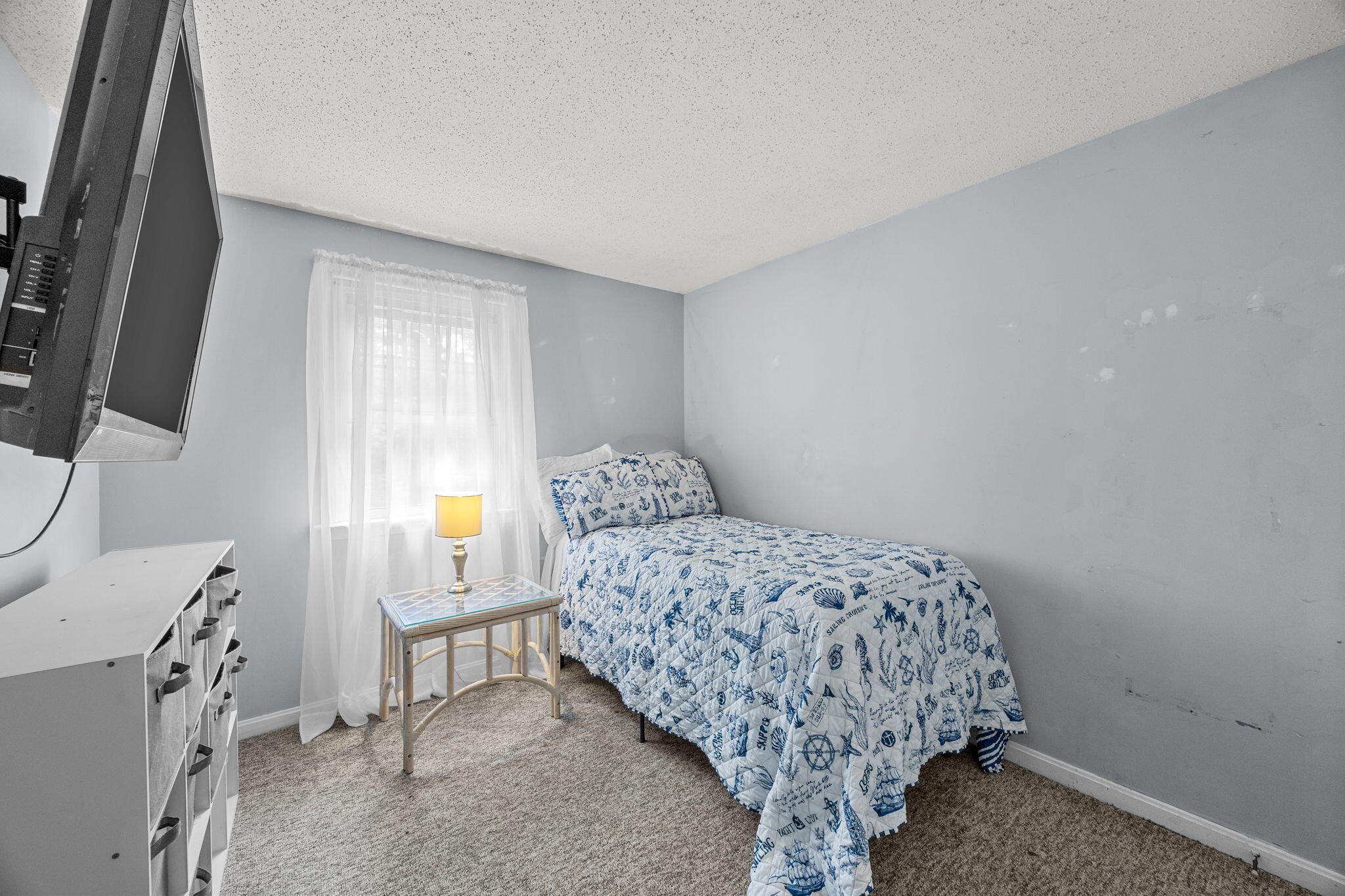 12 Beachwood Road Bourne, MA 02532 - Photo 29 of 64 a bedroom with a bed and a flat tv screen on the dresser