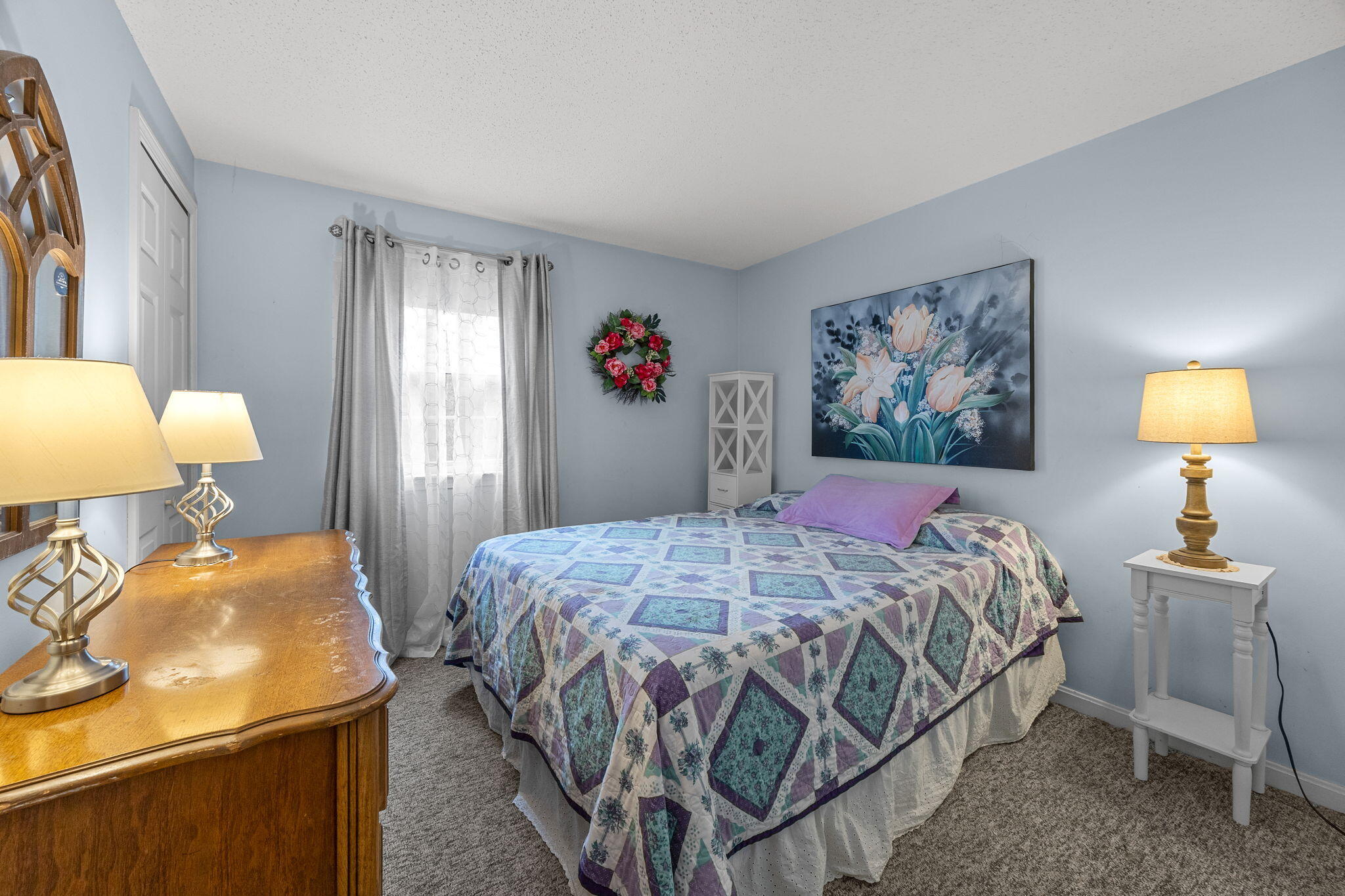 12 Beachwood Road Bourne, MA 02532 - Photo 30 of 64 a bedroom with a bed a mirror and lamp