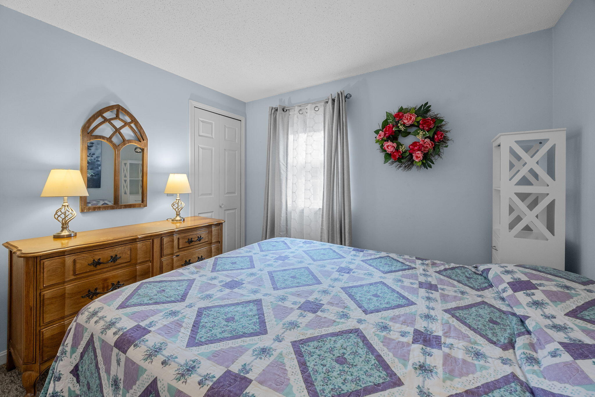 12 Beachwood Road Bourne, MA 02532 - Photo 31 of 64 a bedroom with a large bed and a chandelier